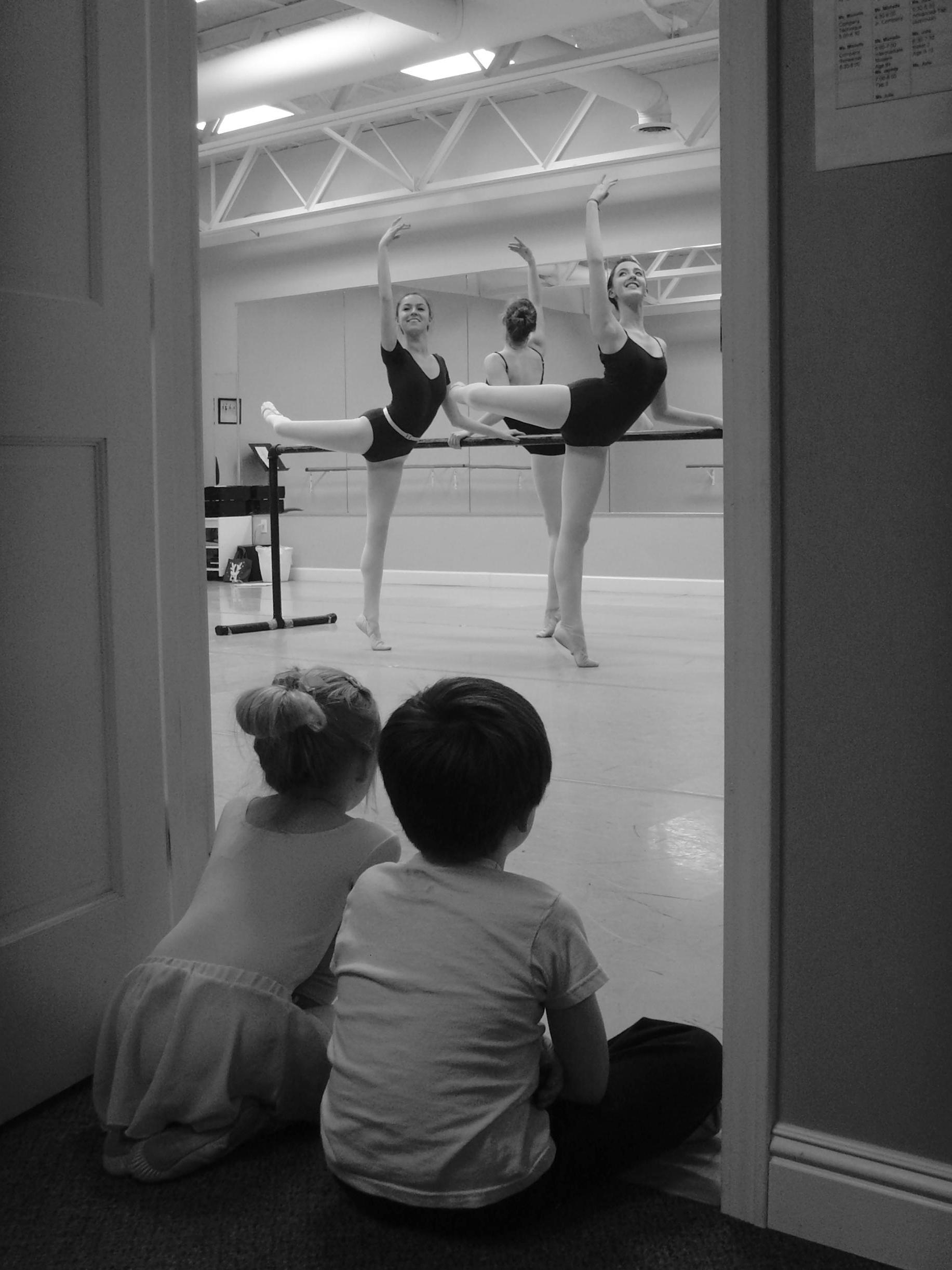 Photo of two dancers being watched by young students